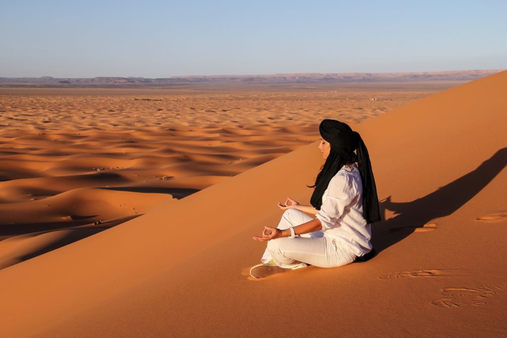 Meditating on the sand dunes. Photo by Lalo Fuentes